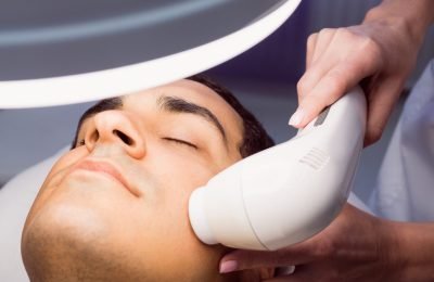 Man getting a facial massage for cosmetic treatment at clinic